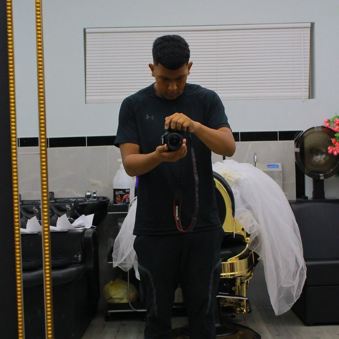 Johnathan Vega holding his Canon camera